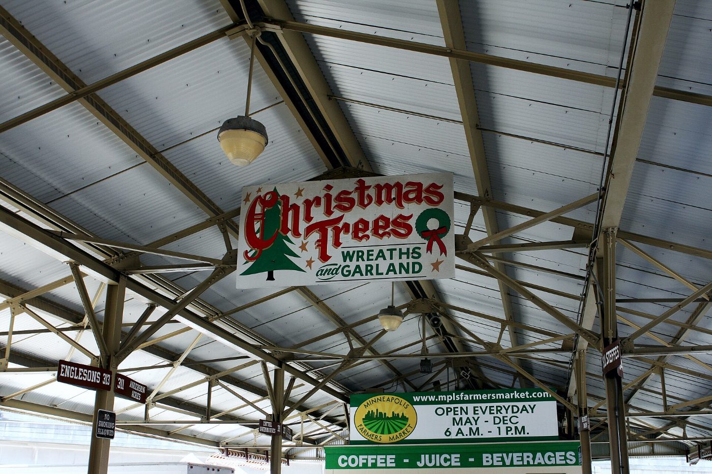Vendor signs under the shed roof of the Minneapolis Farmers Market on Lyndale Avenue